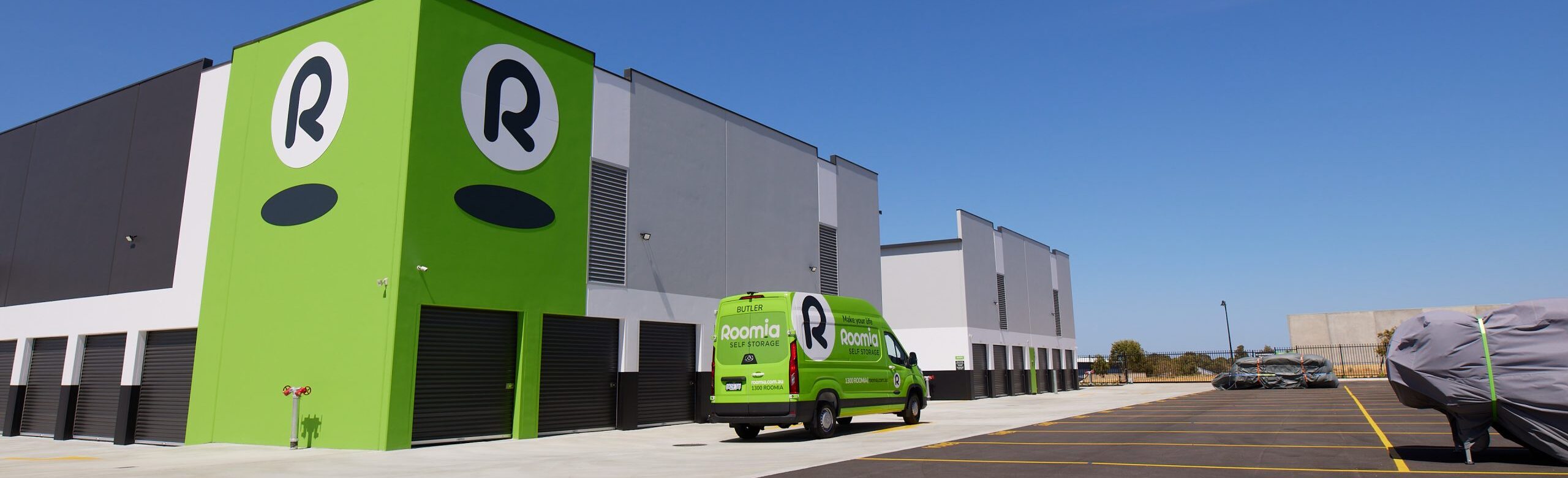 Outdoor vehicle parking 0E2A4238 Free move in van driving on the outside of Roomia self storage facility carpark