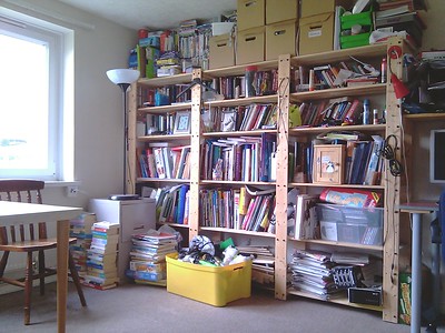 Cluttered room with books and boxes photo