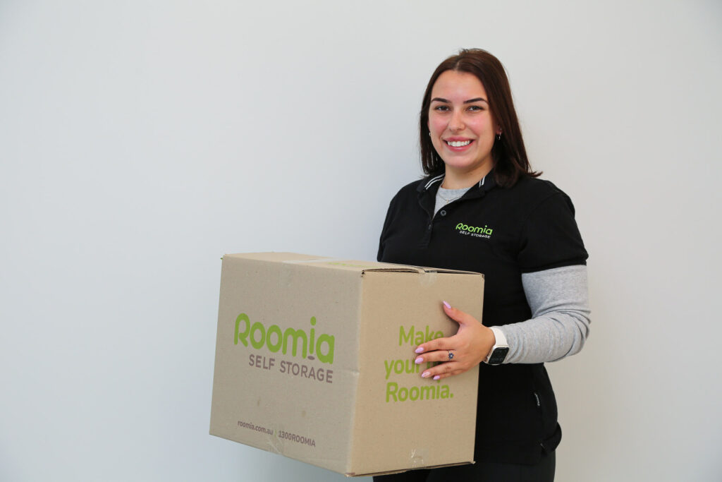 Roomia Oran Park_6618 Bree Oran Park manager holding a Roomia box